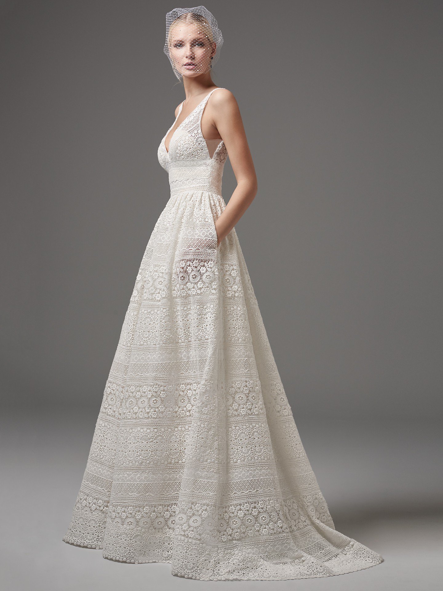 EVAN This chic, boho-inspired A-line features sheer pockets and patterns of eyelet lace, floral motifs, and scalloping. Sheer lace straps complete the V-neckline and sexy square-back. Finished with zipper closure. Detachable tulle overskirt with lace waistband sold separately.